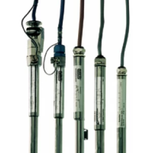 Several level indicator transmitters with stainless steel bodies and attached electrical cables, showcasing industrial liquid level measurement devices.