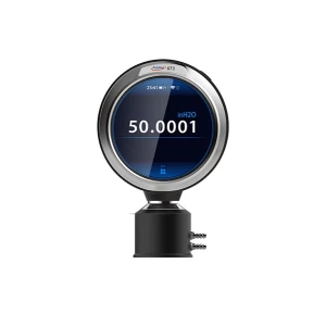 Digital pressure gauge showing a reading of 50.0001 inH2O. The gauge has a circular display with a metallic bezel and a black cylindrical base.