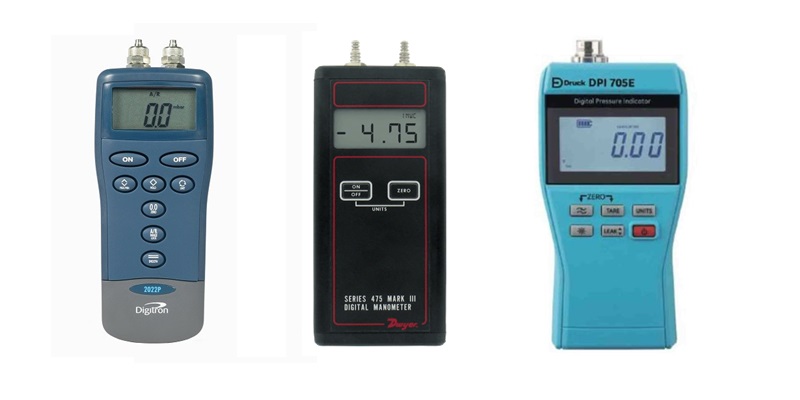 Calibration Services: Three digital manometers for pressure measurement and calibration, including Digitron and Druck models. Precision instruments.