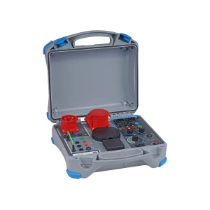 Open electrical test equipment case. Gray with blue accents, featuring various ports, knobs, and buttons for testing electrical systems.